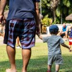 Legacy - Dad and son walking holding hands, walking in the park